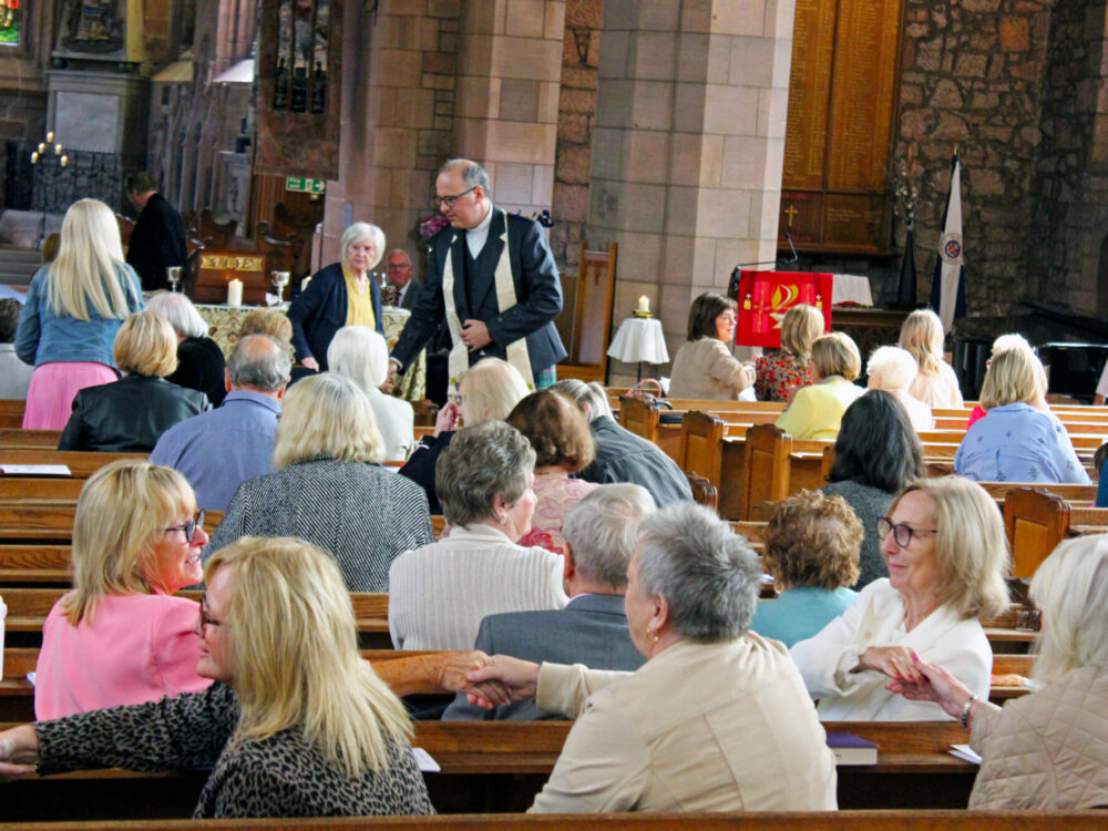 The minister and congregation share the peace.